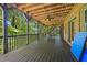 A spacious covered deck with ceiling fans and a ping pong table, perfect for outdoor entertaining at 385 Guildhall Grv, Johns Creek, GA 30022