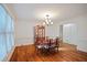 Bright dining room with hardwood floors and classic chandelier at 385 Guildhall Grv, Johns Creek, GA 30022