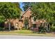 Charming brick home with mature trees in a well-maintained neighborhood at 385 Guildhall Grv, Johns Creek, GA 30022