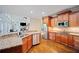 Open concept kitchen with granite countertops, stainless steel appliances, and hardwood floors at 385 Guildhall Grv, Johns Creek, GA 30022
