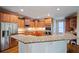 Gourmet kitchen with stainless steel appliances, ample cabinet space, and a granite countertop island at 385 Guildhall Grv, Johns Creek, GA 30022