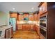 Well-equipped kitchen with stainless steel appliances, granite countertops, and abundant cabinetry at 385 Guildhall Grv, Johns Creek, GA 30022