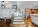 Open concept living area with staircase and stainless steel appliances at 385 Guildhall Grv, Johns Creek, GA 30022