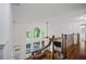 Open loft area with views of the downstairs living room, fireplace, and backyard deck at 385 Guildhall Grv, Johns Creek, GA 30022