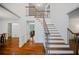 Spacious foyer with hardwood staircase and trim details at 385 Guildhall Grv, Johns Creek, GA 30022