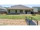 Landscaped backyard with a small metal bridge and covered back porch at 813 Cotton Creek Dr, Canton, GA 30115