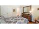 Bedroom features a bed, dresser and mirror, with a door leading to another room at 813 Cotton Creek Dr, Canton, GA 30115
