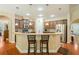 Bright kitchen featuring a breakfast bar with pendant lighting, stainless steel appliances, and hardwood floors at 813 Cotton Creek Dr, Canton, GA 30115