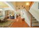 Open-concept living area with hardwood floors, staircase, and views of dining and living spaces at 813 Cotton Creek Dr, Canton, GA 30115