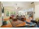 Spacious living room with hardwood floors, a fireplace, and a comfortable seating area at 813 Cotton Creek Dr, Canton, GA 30115