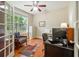 Cozy home office with hardwood floors, a ceiling fan, and a large window at 813 Cotton Creek Dr, Canton, GA 30115
