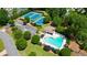 Community amenities include tennis courts and swimming pool with surrounding lush green landscaping and trees at 9050 Brockham Way, Alpharetta, GA 30022