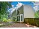 View of the backyard of this home, featuring a fenced-in yard with a patio area at 9050 Brockham Way, Alpharetta, GA 30022