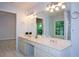 The primary bathroom features double sinks and a soaking tub under a bright window at 9050 Brockham Way, Alpharetta, GA 30022
