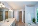 The open primary bathroom features double sinks, walk-in shower, soaking tub, and walk-in closet at 9050 Brockham Way, Alpharetta, GA 30022