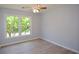Light and bright bedroom featuring a ceiling fan and large window at 9050 Brockham Way, Alpharetta, GA 30022