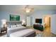 This primary bedroom features an ensuite bathroom, sitting area, fan, and modern decorations at 9050 Brockham Way, Alpharetta, GA 30022