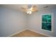Bedroom with a ceiling fan, window and neutral paint at 9050 Brockham Way, Alpharetta, GA 30022
