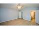 Spacious bedroom featuring hardwood floors, neutral walls, and multiple doorways to other rooms at 9050 Brockham Way, Alpharetta, GA 30022