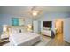 This primary bedroom features an ensuite bathroom, sitting area, fan, and stylish decorations at 9050 Brockham Way, Alpharetta, GA 30022