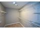 Walk in closet features wire shelving and luxury vinyl plank flooring at 9050 Brockham Way, Alpharetta, GA 30022