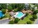 Aerial view of community pool surrounded by lounge chairs, trees, pool house, and well-maintained landscaping at 9050 Brockham Way, Alpharetta, GA 30022