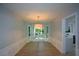 Bright dining room with bay window, modern chandelier, and wood-look floors at 9050 Brockham Way, Alpharetta, GA 30022