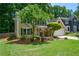 Beautiful home features manicured lawn, mature trees, and a two-car garage at 9050 Brockham Way, Alpharetta, GA 30022