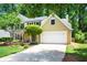 Traditional two-story home with a well-maintained lawn, landscaping, and attached garage at 9050 Brockham Way, Alpharetta, GA 30022