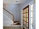 Bright foyer with hardwood floors, staircase, and paneled front door at 9050 Brockham Way, Alpharetta, GA 30022