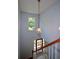 Elegant foyer with statement lighting, hardwood floors, and a paneled front door at 9050 Brockham Way, Alpharetta, GA 30022