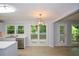 Bright kitchen features white cabinetry, stainless steel appliances, and backyard views at 9050 Brockham Way, Alpharetta, GA 30022
