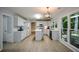 Open kitchen features white cabinetry, stainless steel appliances, and backyard views at 9050 Brockham Way, Alpharetta, GA 30022