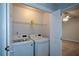 Bright laundry room with a washer, dryer and shelving at 9050 Brockham Way, Alpharetta, GA 30022