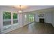 Bright living room with hardwood floors, large windows, and a fireplace, perfect for relaxation at 9050 Brockham Way, Alpharetta, GA 30022