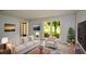Airy living room with natural light, contemporary furniture, and wood-look flooring at 9050 Brockham Way, Alpharetta, GA 30022