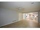 Spacious living room showcasing hardwood floors and an open layout leading to the modern, white kitchen at 9050 Brockham Way, Alpharetta, GA 30022