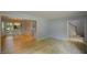 Open concept living room with wood-look floors, access to a dining area, and a stairway at 9050 Brockham Way, Alpharetta, GA 30022