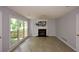 Open living room features fireplace, large windows, and modern flooring at 9050 Brockham Way, Alpharetta, GA 30022