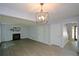 Living room featuring wood floors, a fireplace and staircase access at 9050 Brockham Way, Alpharetta, GA 30022
