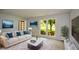 Bright living room with modern decor, featuring a large window and comfortable seating at 9050 Brockham Way, Alpharetta, GA 30022