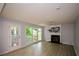 Bright living room features fireplace, large windows, and patio access at 9050 Brockham Way, Alpharetta, GA 30022