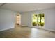 Bright living room featuring wood-look floors, a large window, and a view to another room at 9050 Brockham Way, Alpharetta, GA 30022