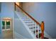 View of the bright staircase with hardwood steps and white banisters and wainscotting at 9050 Brockham Way, Alpharetta, GA 30022