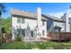 Back exterior featuring deck, concrete patio, and green lawn at 5712 Grande River Rd, Atlanta, GA 30349