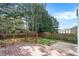 Private backyard features a wooden deck, lush lawn, and mature trees, perfect for outdoor relaxation at 5712 Grande River Rd, Atlanta, GA 30349