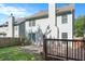 Exterior rear view of the home with wooden deck, patio, and fenced in backyard space at 5712 Grande River Rd, Atlanta, GA 30349