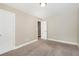 A well-lit bedroom featuring neutral paint, carpet and a closet at 5712 Grande River Rd, Atlanta, GA 30349