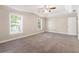 Bright bedroom features neutral walls, carpeting, windows and a tray ceiling at 5712 Grande River Rd, Atlanta, GA 30349