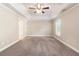 Large bedroom with tray ceiling, neutral paint, carpet and a ceiling fan at 5712 Grande River Rd, Atlanta, GA 30349